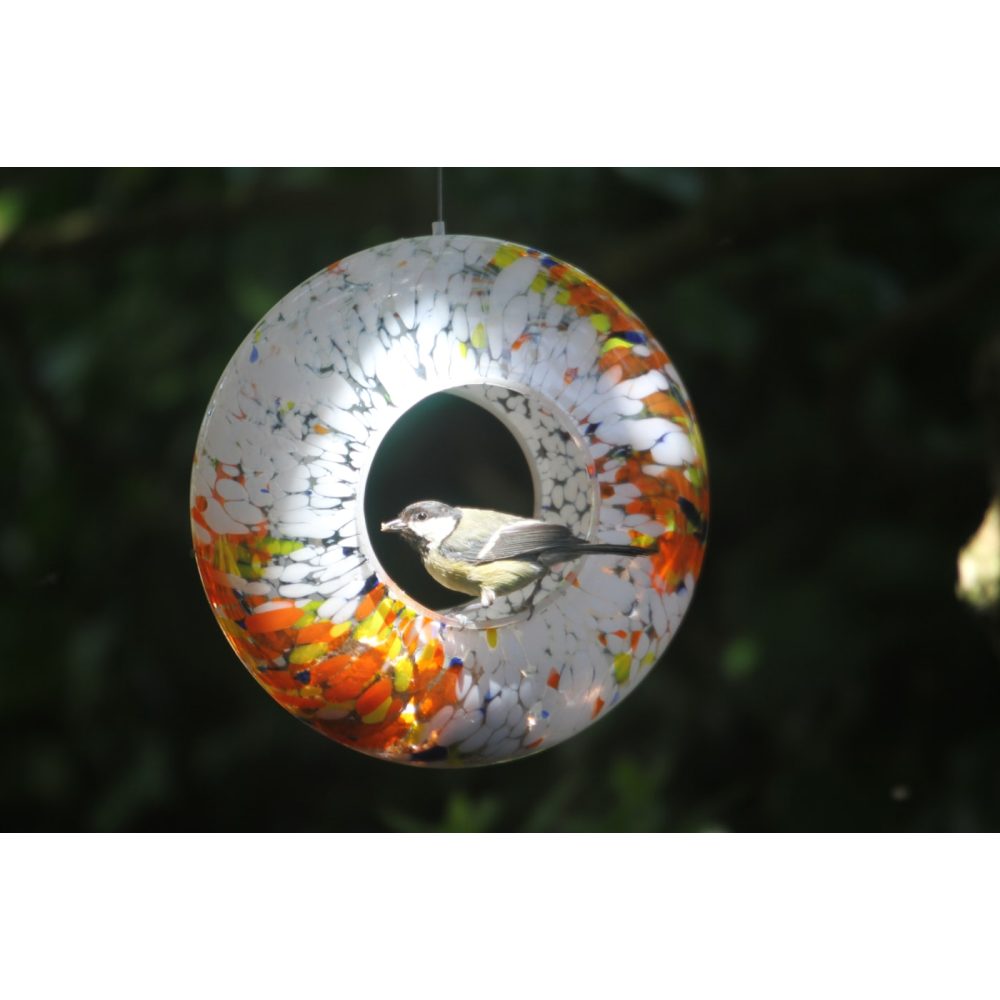 Hanging metal bird feeder in a garden